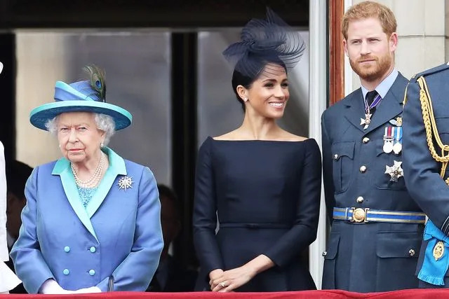 Chris Jackson/Getty Queen Elizabeth, Meghan Markle and Prince Harry on the balcony of Buckingham Palace on July 10, 2018.