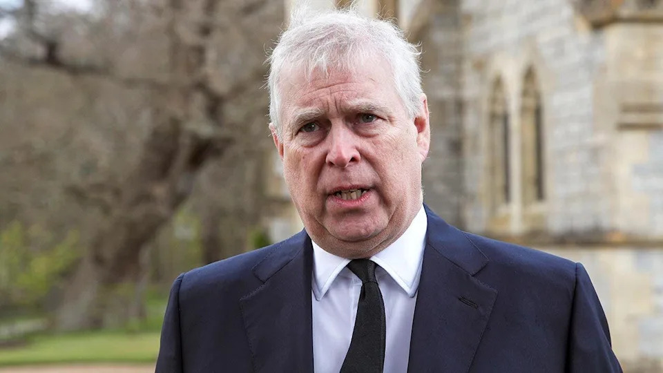 Prince Andrew looking serious in a suit.