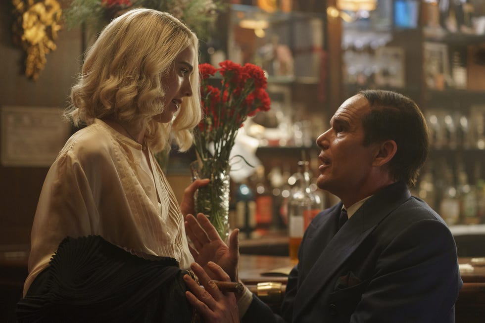 margaret qualley and ethan hawke in conversation at a bar in blue moon