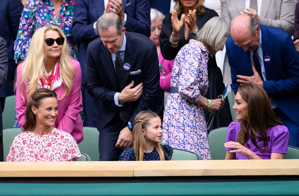 Pippa Middleton wearing a pink dress sitting next to Princess Charlotte and Kate Middleton at Wimbledon 2024