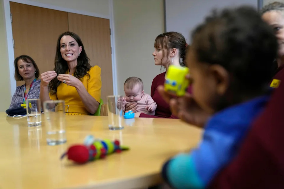 Kate Middleton wears a yellow dress to visit the Royal Surrey County Hospital's Maternity Unit on October 5, 2022