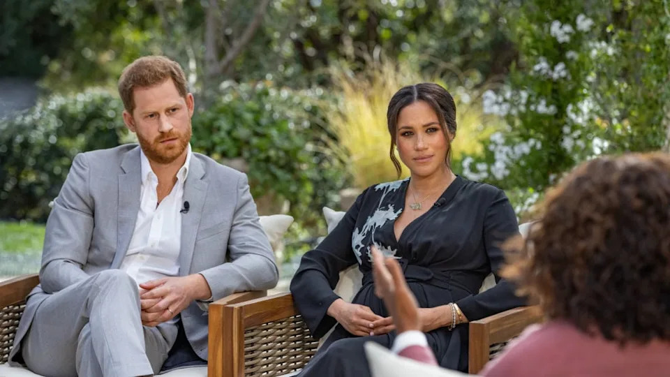 The royals are nervous that Prince Harry, pictured here with wife Meghan Markle during a tell-all interview with Oprah, could betray more royal secrets. / Photo by Harpo Productions/Joe Pugliese via Getty Images