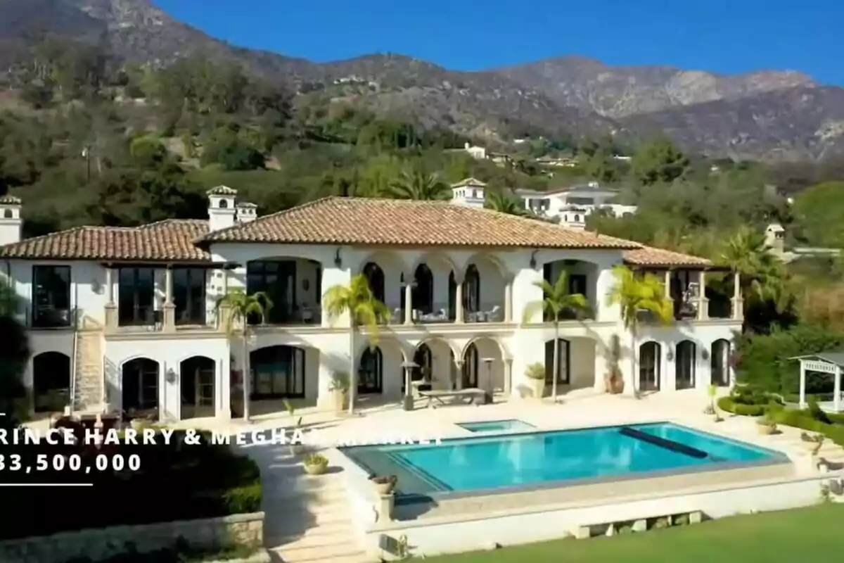 A luxurious mansion with a swimming pool and a mountainous landscape in the background.