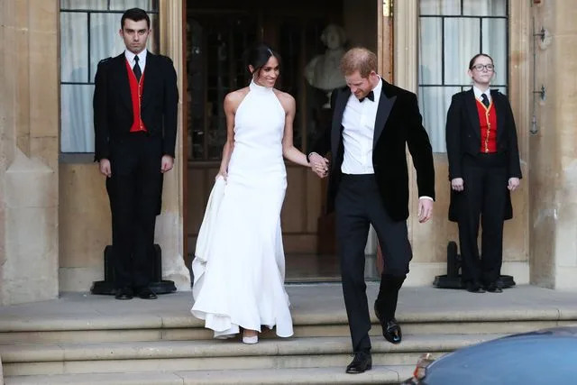 STEVE PARSONS/AFP via Getty Meghan Markle and Prince Harry leave Windsor Castle on May 19, 2018 after their wedding to attend an evening reception at Frogmore House.