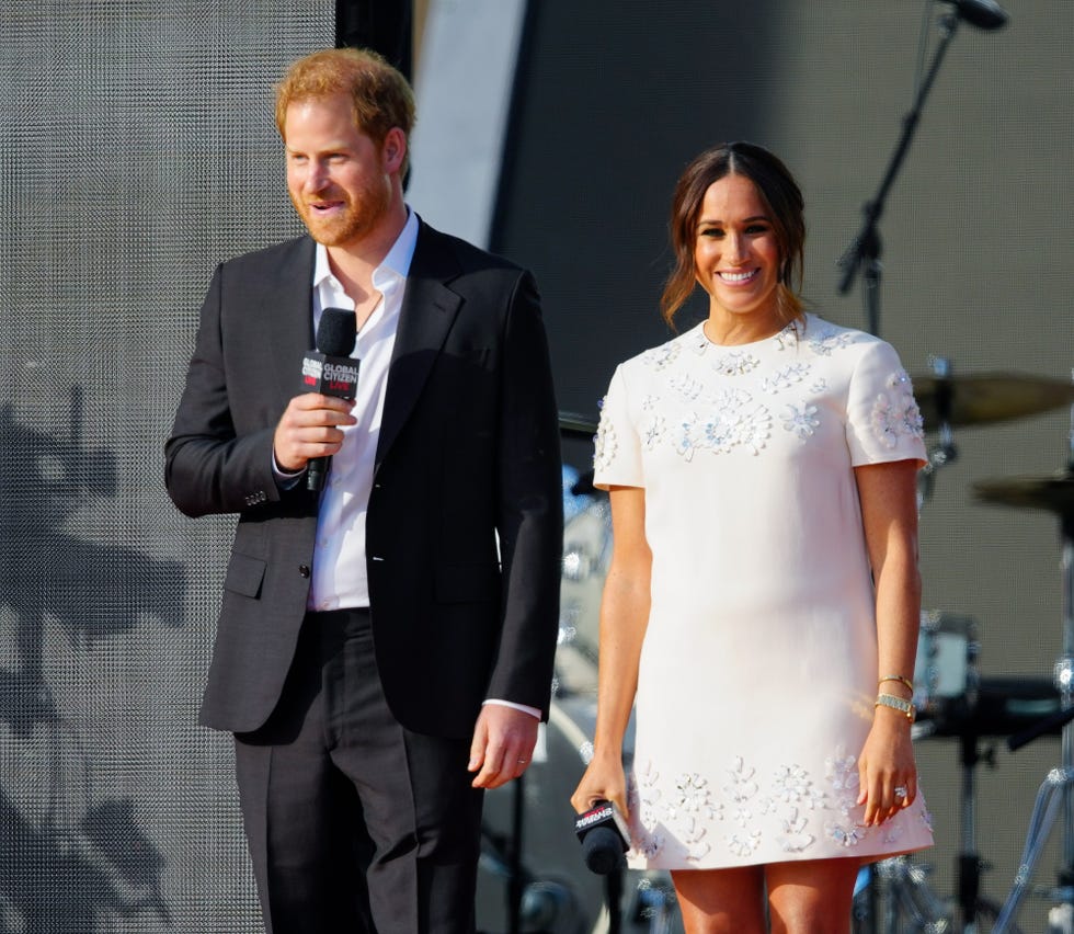 two individuals speaking at a public event