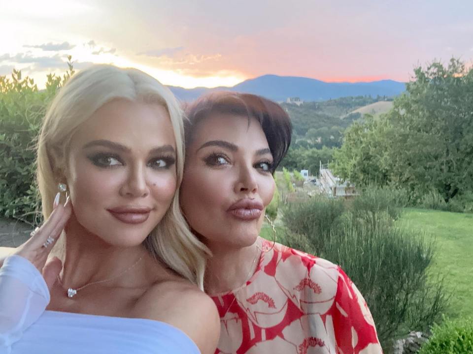 Khloe Kardashian and Kris Jenner taking a selfie at sunset.
