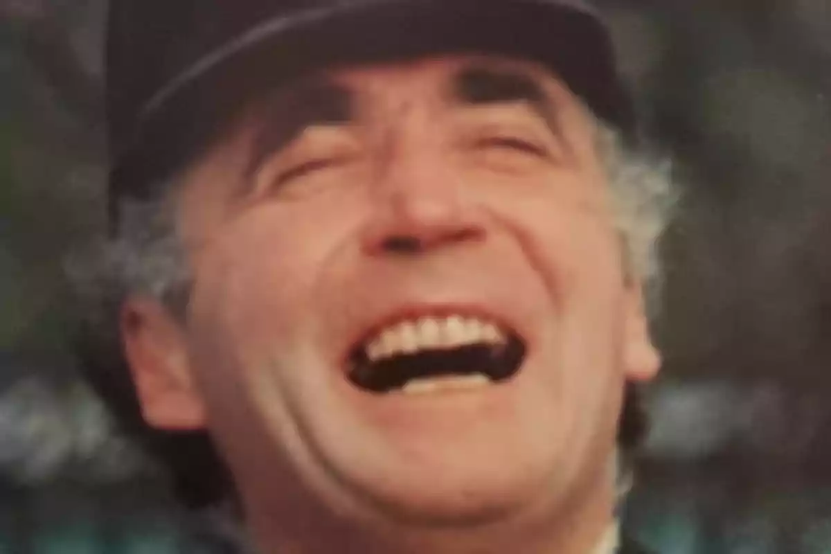 Ian Farquhar wearing a hat laughing out loud