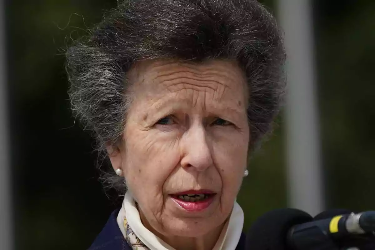 Princess Anne speaking in front of a microphone outdoors