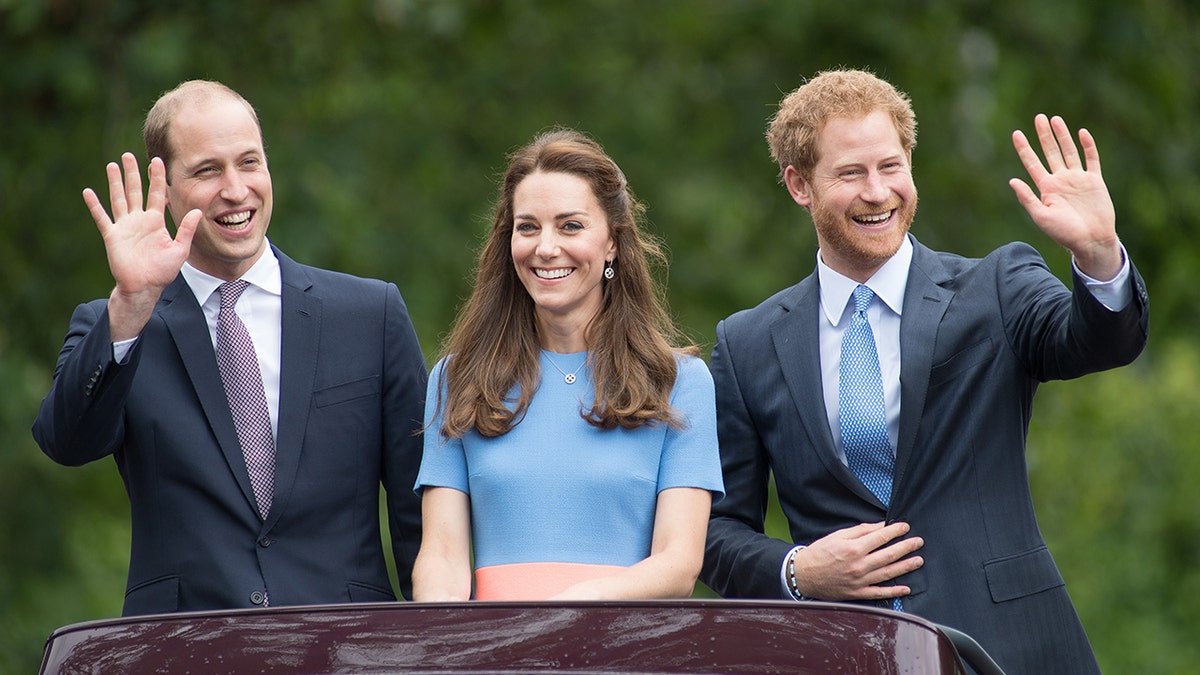 Prince Harry and Prince William waving as Kate Middleton smiles during a royal engagement.