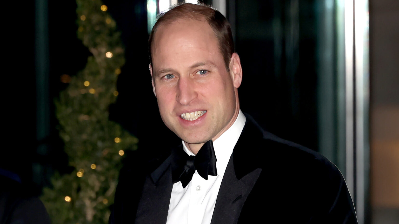 Prince William wearing a tuxedo and smiling