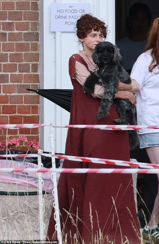 Emma Corrin seen for the first time as Elizabeth Bennet on the set of Pride and Prejudice (also pictured cuddling their dog Spencer between takes)