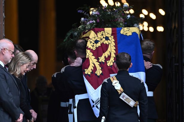The coffin of the Duchess of Kent, draped in the Royal Standard, is carried into Westminster Cathedral as her husband the Duke of Kent and daughter Lady Helen Taylor bow their heads 