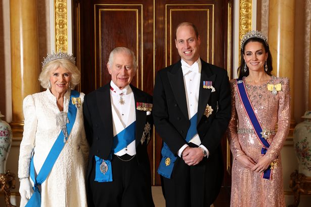 Queen Camilla, King Charles III, Prince William, Prince of Wales and Catherine, Princess of Wales pose for a photograph ahead of The Diplomatic Reception in the 1844 Room at Buckingham Palace on December 05, 2023 in London