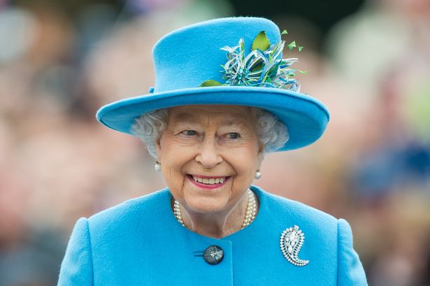 Queen elizabeth in blue jacket and hat 