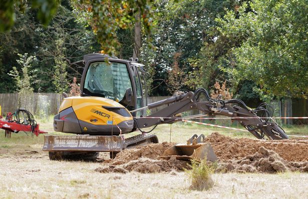 Digger parked on grounds of the Lodge which have been dug up and cordoned off for renovation