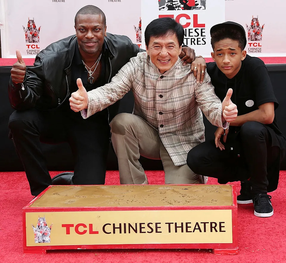 Three individuals pose and give thumbs up at TCL Chinese Theatre