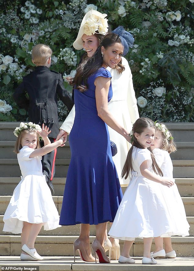 Kate and Canadian fashion stylist Jessica Mulroney hold bridesmaids hands as they arrive for the wedding ceremony of  Harry and Meghan at St George's Chapel