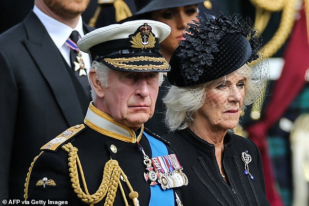 King Charles III and Queen Camilla at the late Queen's funeral. A source claimed that 'Charles made it very, very clear Meghan would not be welcome' at Balmoral