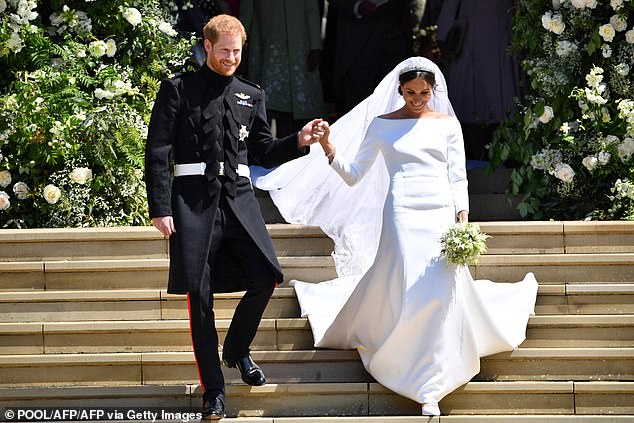 Harry and Meghan are pictured on their wedding day on May 19, 2018 after their wedding ceremony
