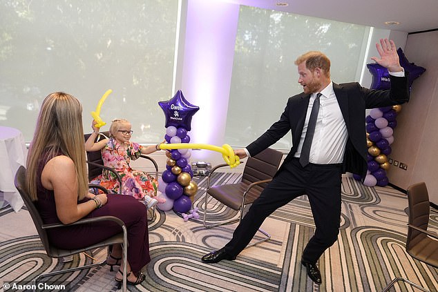 Prince Harry play fights with a young girl at the WellChild Awards in London on September 8