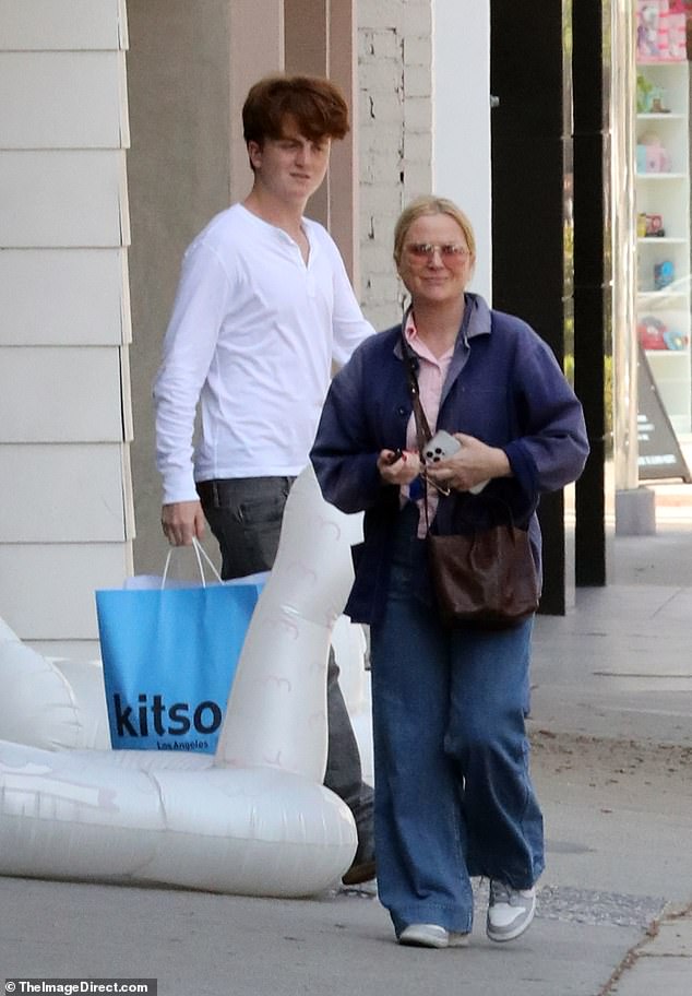 Amy Poehler was joined by her rarely-seen 15-year-old son Abel out in LA on Sunday as he towered over his famous mother who is listed as 5feet2 on the errand trip