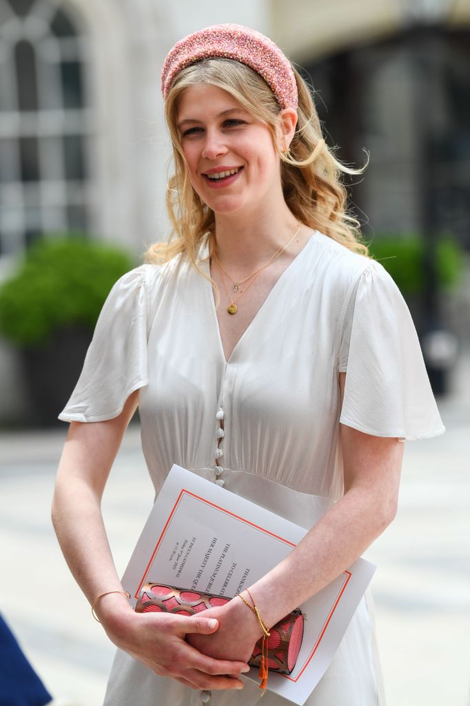 Lady Louise smiling in white dress and pink headband