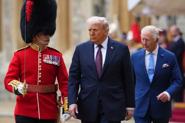 WINDSOR, ENGLAND - SEPTEMBER 17: US President Donald Trump (C) and King Charles III (R) review the Guard of Honour after arrival at Windsor Castle on day two of the US President Donald Trump's second state visit to the UK on September 17, 2025 in Windsor, England. (Photo by Kirsty Wigglesworth - WPA Pool/Getty Images)