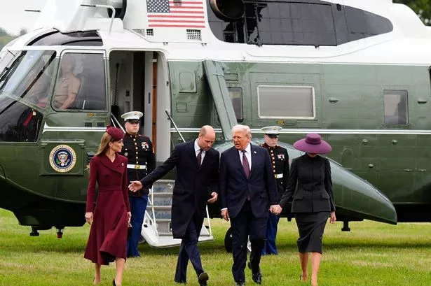 Two women and two men near an aircraft