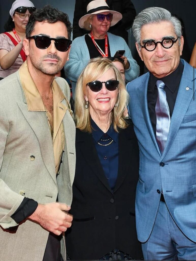 Dan Levy on the red carpet of "Lilith Fair: Building a Mystery" with parents Eugene Levy and Deborah Divine at TIFF 2025