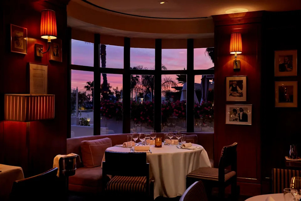Elegant dining setting with a view of a sunset.