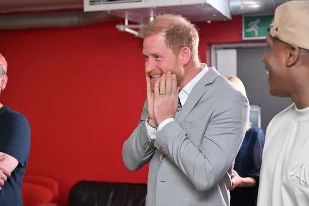 Harry looks animated during his visit