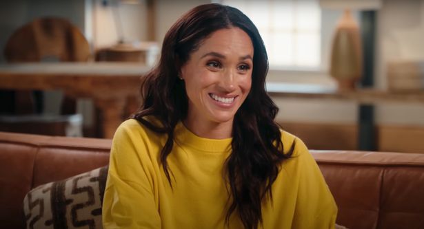 Meghan markle smiling in yellow top