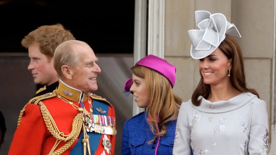 Prince Philip and Kate Middleton smiling at each other from Buckingham Palace.