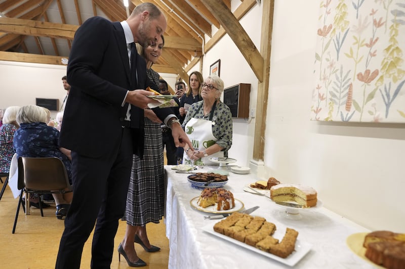 The Prince and Princess of Wales choose a cake during their visit