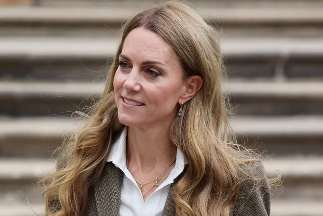 Neil Mockford/GC Images Kate Middleton wears a necklance with her children's initials during a visit to the Natural History Museum on Sept. 4, 2025