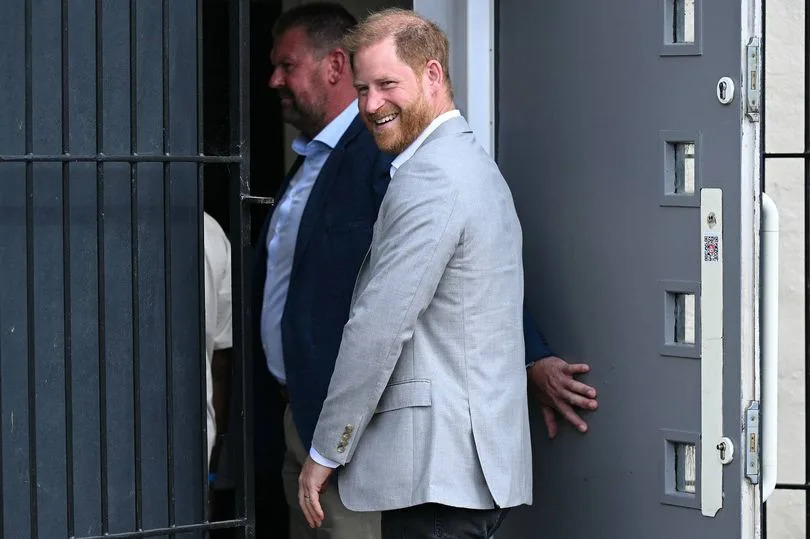 Harry laughs as he arrives at the Community Recording Studio (CRS) in Nottingham