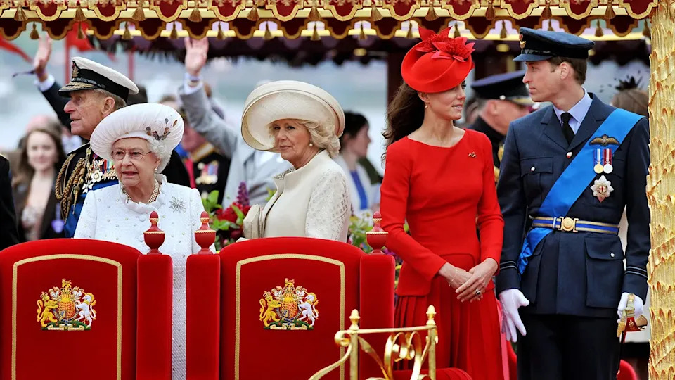 Kate Middleton standing next to her husband Prince William as the rest of the royal family looks on.