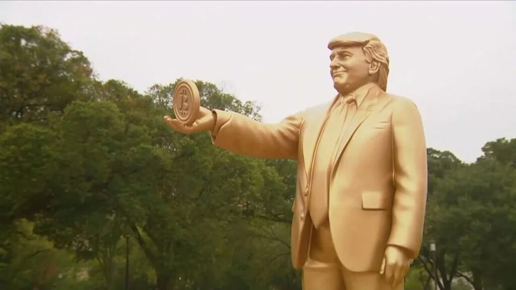 A 12-foot golden statue of Donald Trump holding a Bitcoin was unveiled outside the Capitol on 3rd Street.