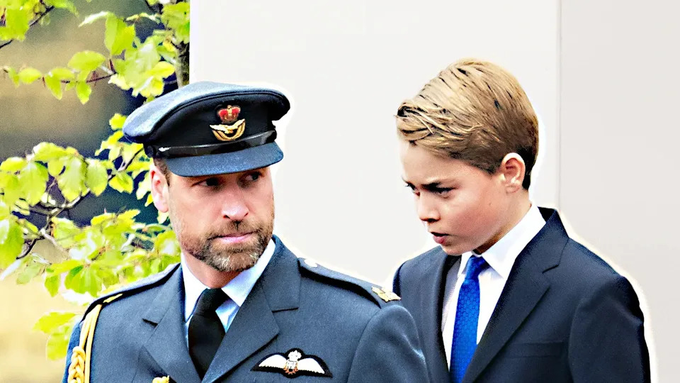 Prince William in uniform walking ahead of his son Prince George at VE Day in London.