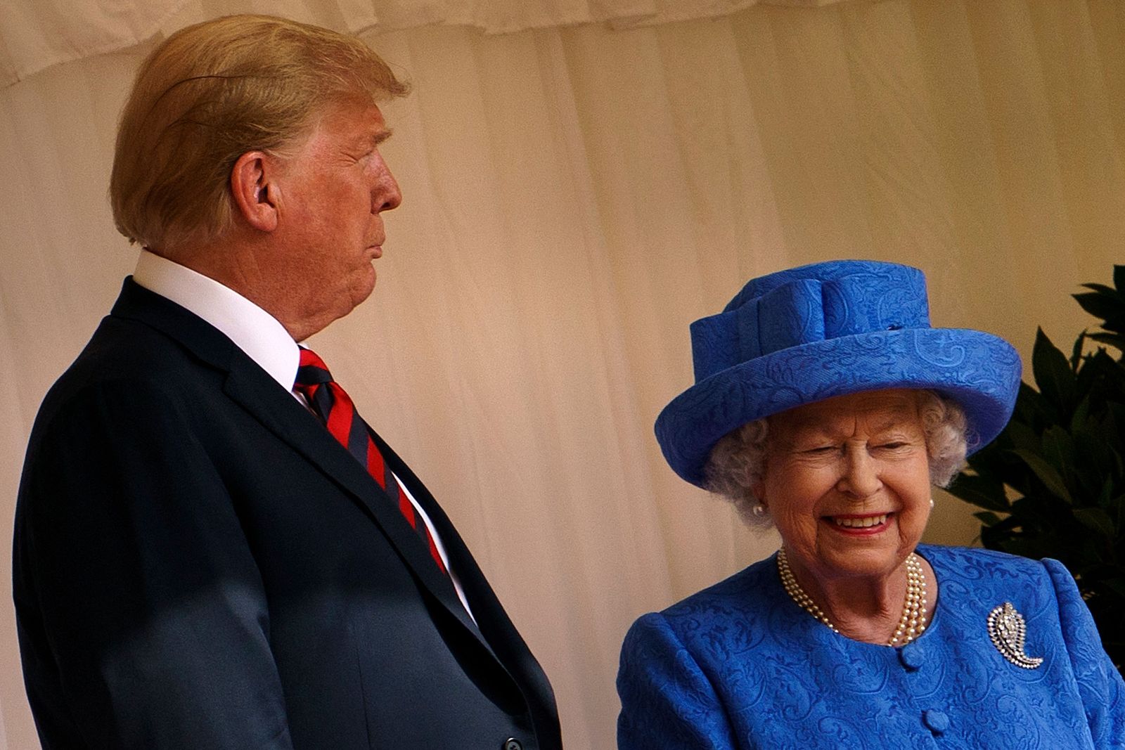 President Donald Trump speaks with Britain's Queen Elizabeth II after he inspected the Guard of Honour at Windsor Castle...