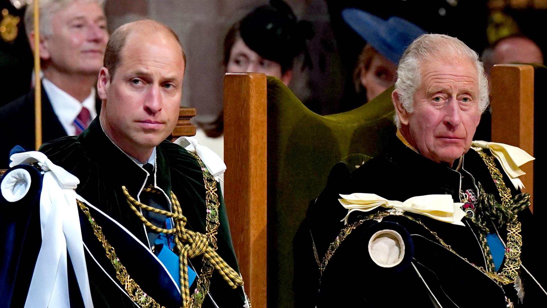 Prince William and King Charles wearing ceremonial robes and military medals