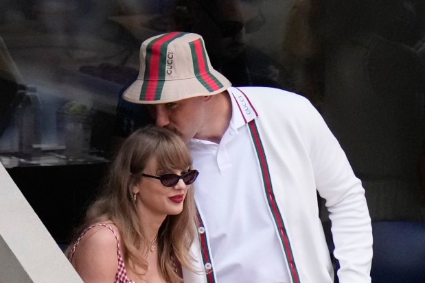 FILE - Taylor Swift gets a kiss from Kansas City Chiefs tight end Travis Kelce as they arrive to watch play between Jannik Sinner, of Italy, and Taylor Fritz, of the United States, during the men's singles final of the U.S. Open tennis championships, Sept. 8, 2024, in New York. (AP Photo/Frank Franklin II, File)