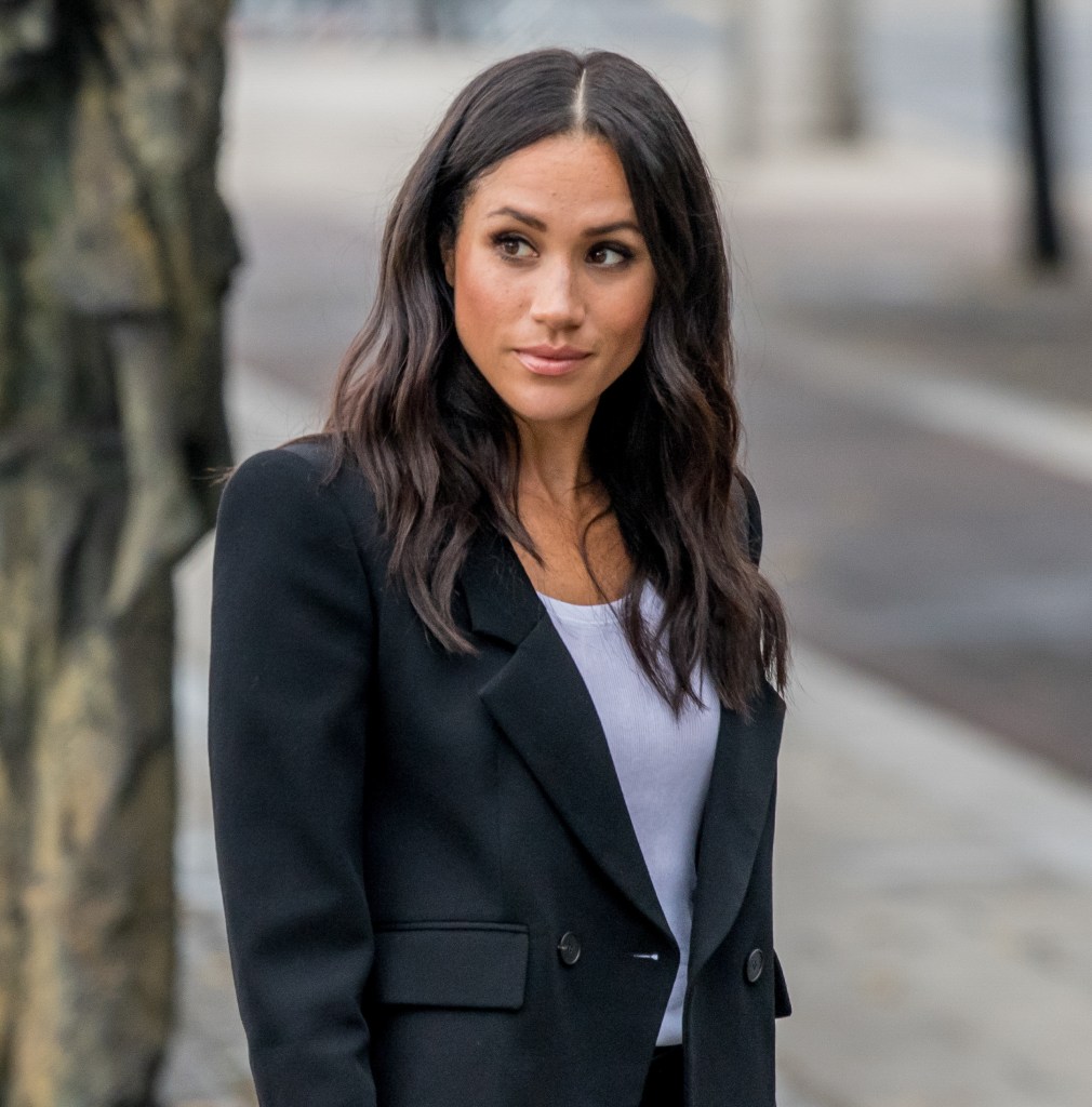 Meghan Markle looks to the side