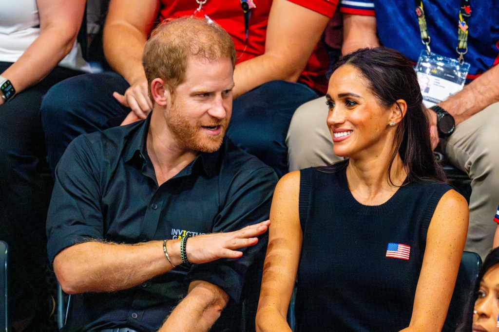 Prince Harry and Meghan Markle laughing together at event