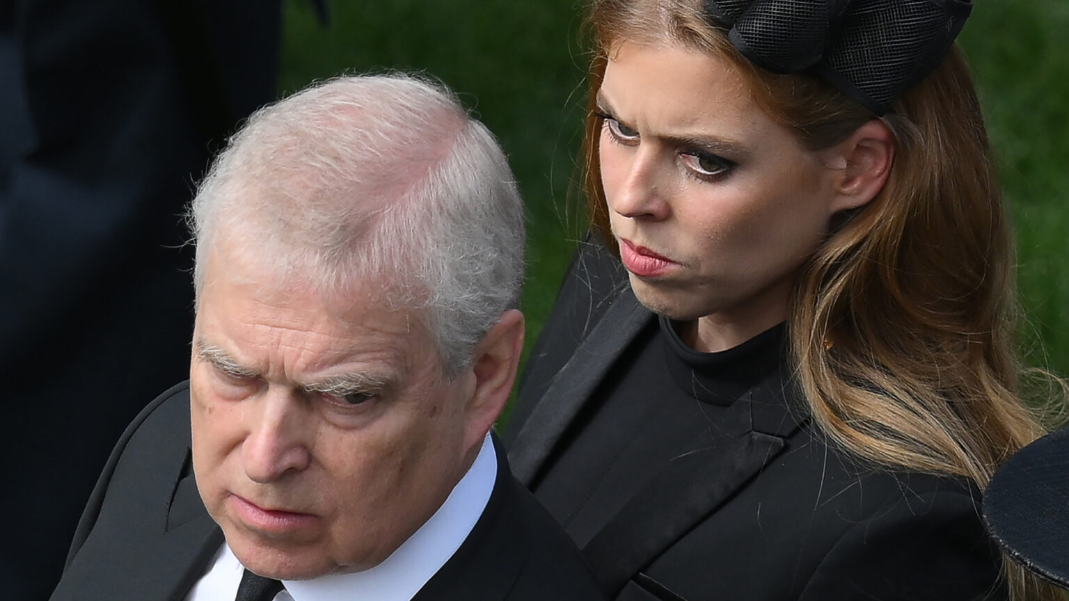 Prince Andrew Destroyed Beatrice’s Future, Per Royal Source Prince Andrew looks stern wearing a suit and Princess Beatrice wears a black dress