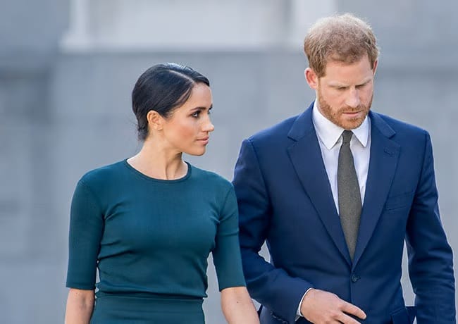 Prince Harry and Meghan Markle both wearing blue