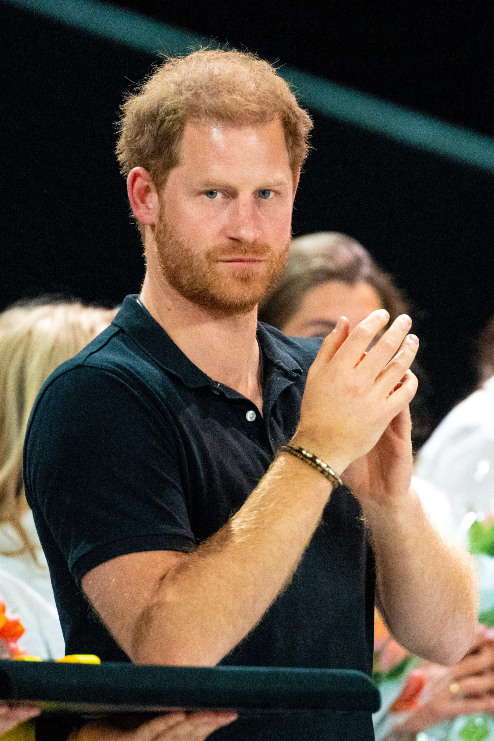 Prince Harry clapping and looking to camera