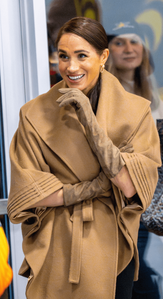 Meghan Markle wearing a brown coat and gloves
