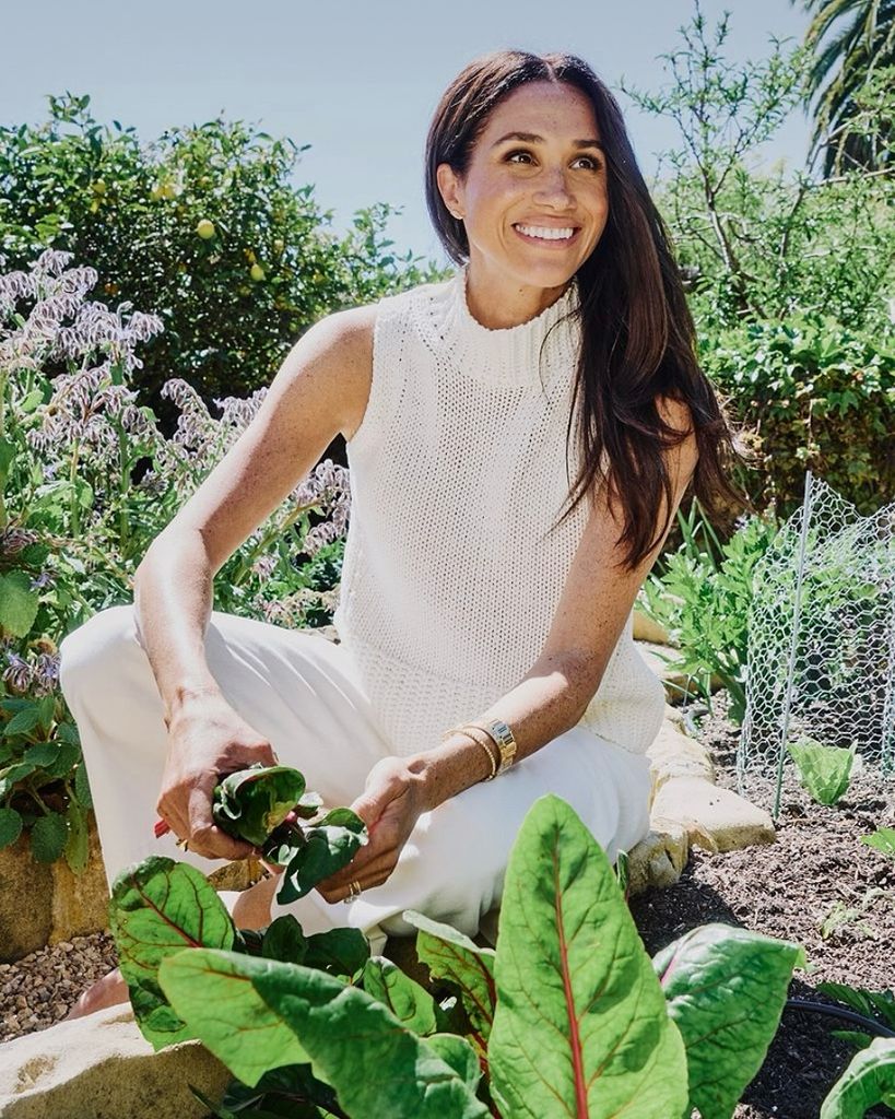 Meghan Markle poses in a garden