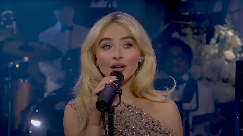Sabrina Carpenter performing in sparkly dress at SNL 50. .